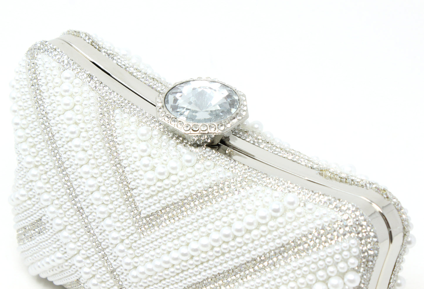 White beaded clutch with a central gemstone on a white background