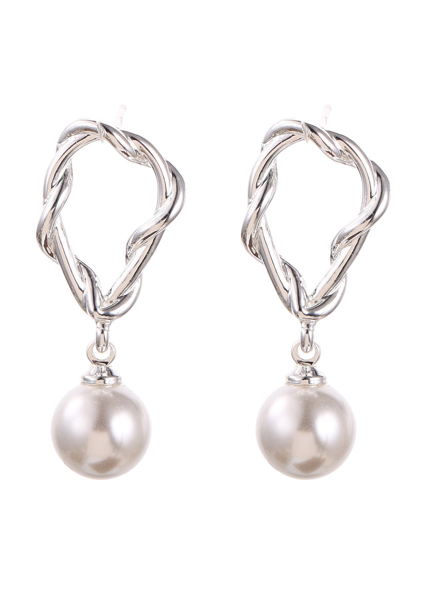 Pair of silver earrings with pearl drops on a white background