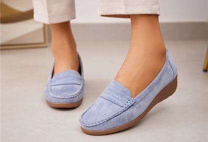A pair of light blue microfibre round toe slip-on loafers with stitching details and a 3.5cm wedge heel.