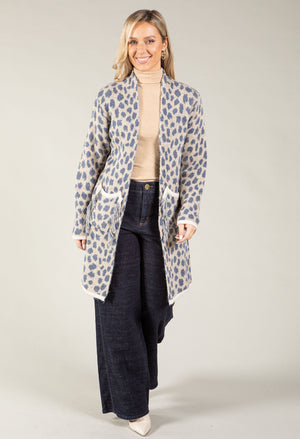 A woman modeling a light gray open-front coat with a blue-gray leopard print pattern.