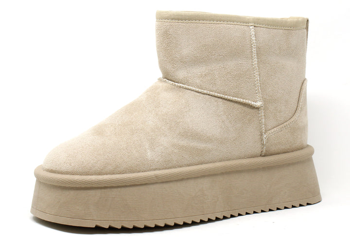 A beige faux fur lined platform ankle boot with a round toe and slip-on style.