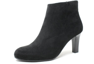 A black ankle boot with a round toe, slim heel, and zip closure. The boot has a faux suede finish.