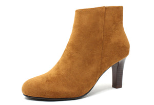 A tan ankle boot with a round toe, slim heel, and zip closure. The boot has a faux suede finish.