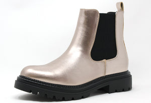 A metallic finish boot with a contrast black sole, featuring a round toe and a block heel.