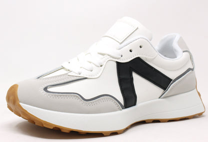A pair of black and white faux suede and faux leather sneakers with a cleated sole and lace-up style.
