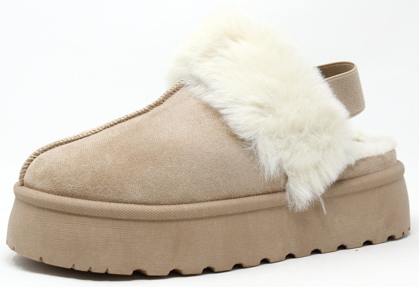 A beige flatform slip on boot with fur lining around the top edge and an elastic ankle strap.