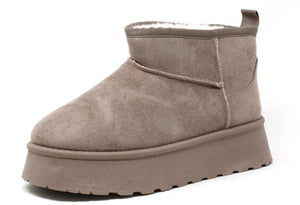Taupe faux fur lined platform boots with a round toe design.