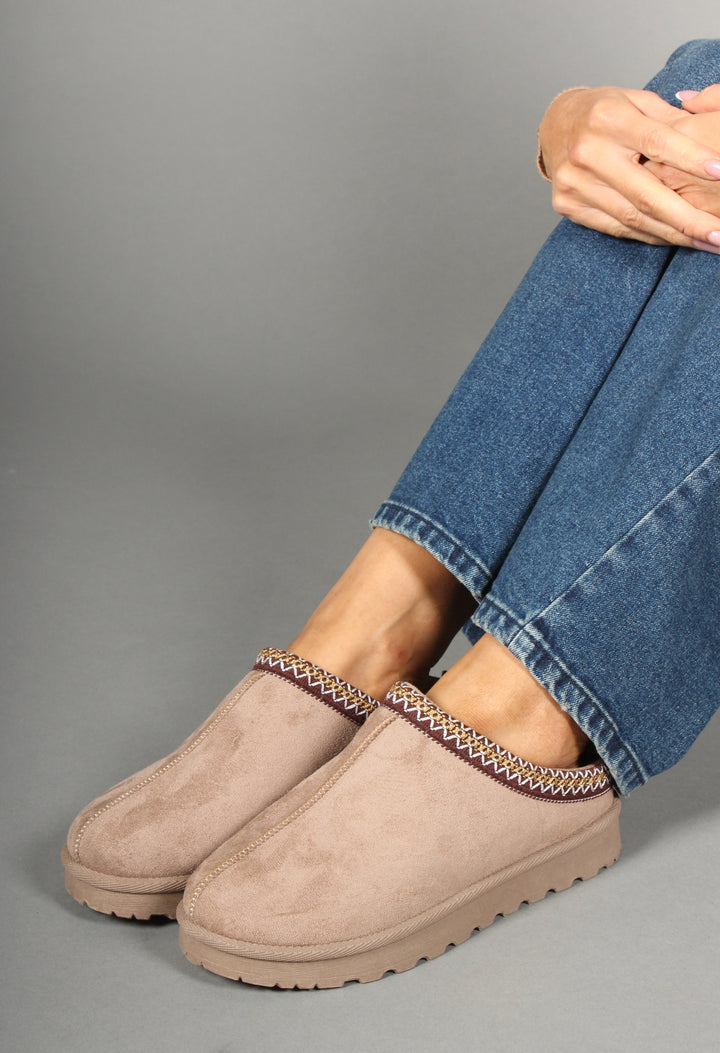 embroidered slip on shoe worn by model wearing blue denim jeans