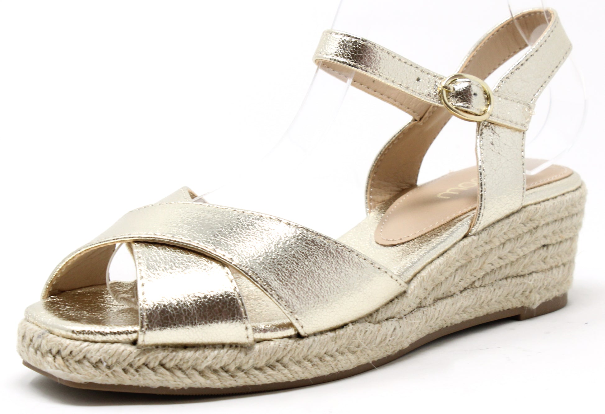 A metallic gold espadrille sandal with adjustable ankle strap and cross straps at the toe, featuring a wedge heel.