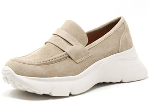 A beige faux suede wedge penny loafer with a round toe and chunky sole.