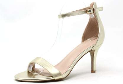 Gold high-heeled sandal on a white background