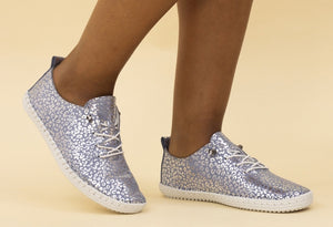 A pair of blue and white leather plimsolls with a metallic leopard print and whip stitched detail.