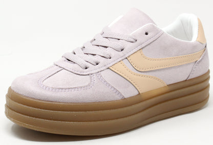 A pair of color-blocked platform sneakers with faux suede texture, lace-up closure, and a thick sole.