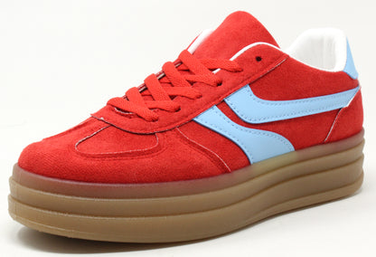 A pair of color-blocked platform sneakers with faux suede texture, lace-up closure, and a thick sole.