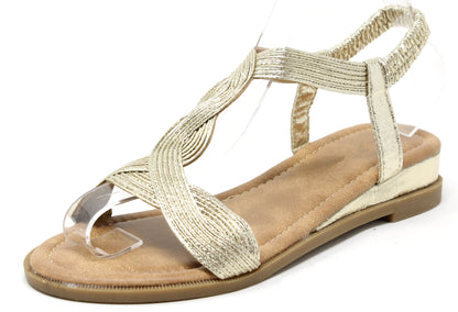gold sandal with braided design on a white background