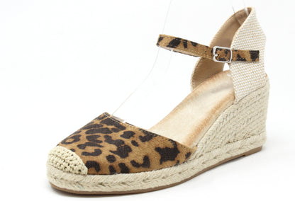 Leopard print wedge sandal with espadrille sole on a white background