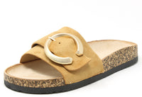 Beige sandal with a circular buckle on a white background