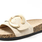 Beige slide sandal with a gold buckle on a white background