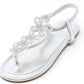 Silver sandal with decorative straps on a white background