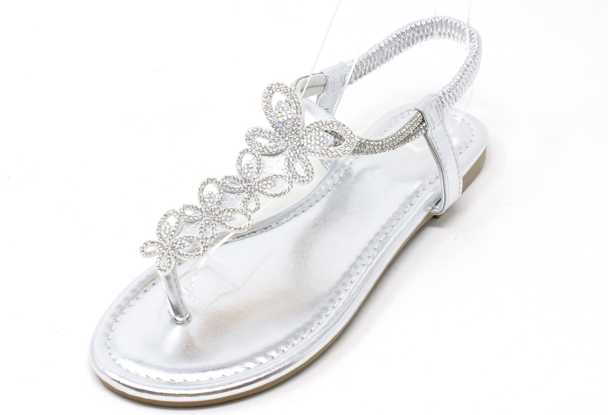 Silver sandal with decorative straps on a white background