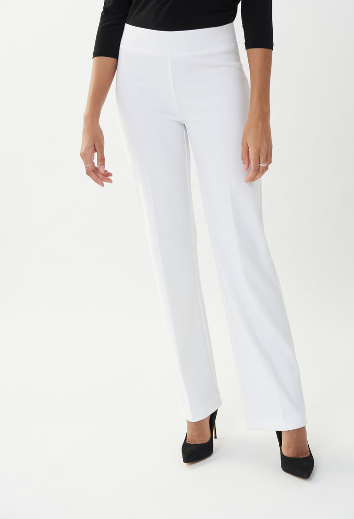 White pants worn by a person on a white background