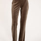 Brown velvet pants worn by a person on a white background