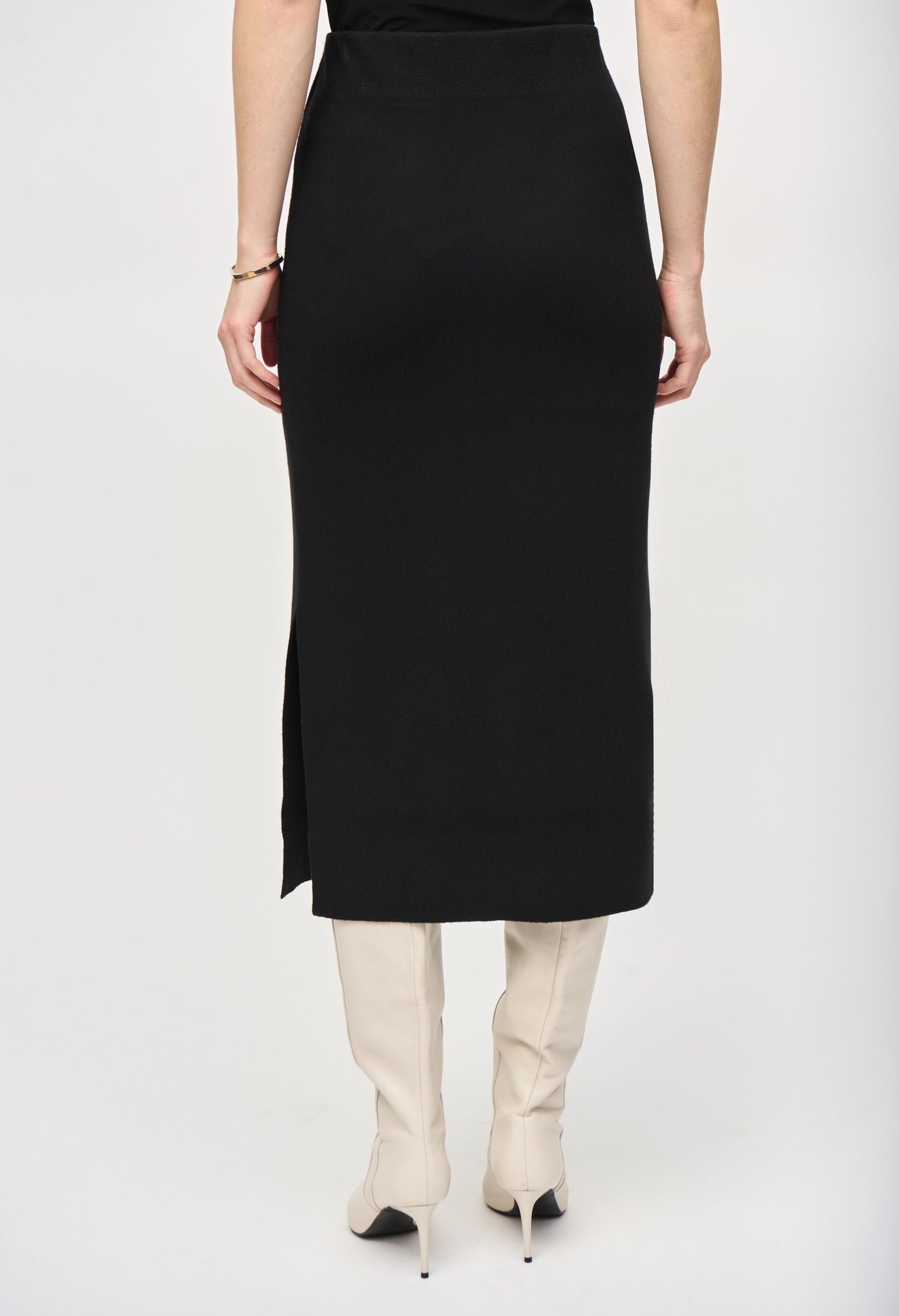 Person wearing a black skirt with a white background