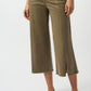 Person wearing olive green wide-leg pants on a white background
