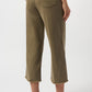 Person wearing olive green pants on a white background