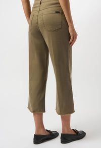 Person wearing olive green pants on a white background