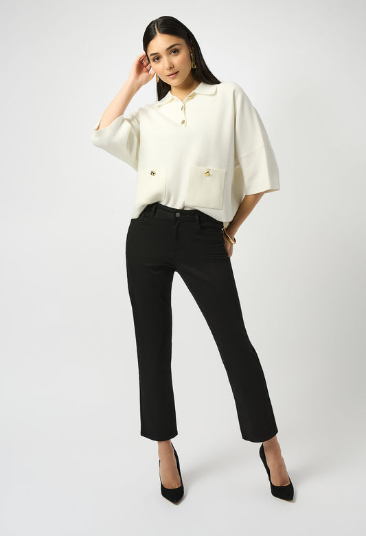 Woman wearing a white blouse and black pants on a white background