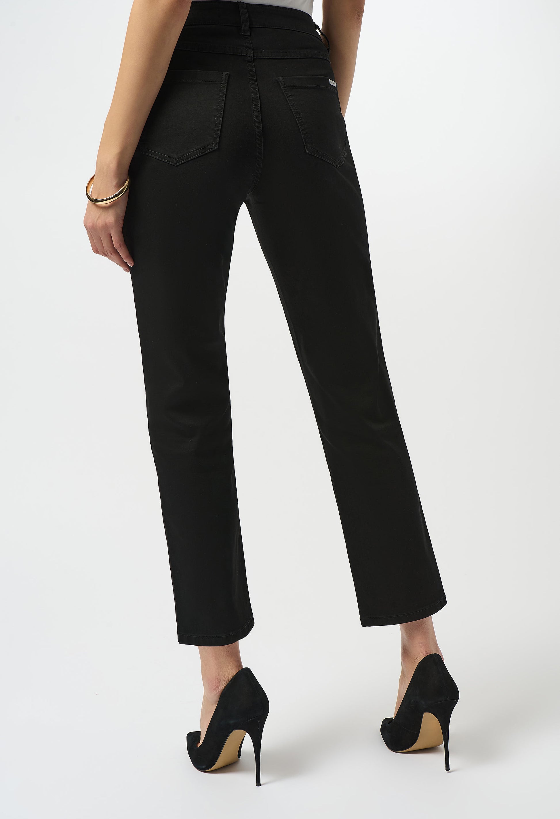 Black pants worn by a person on a white background
