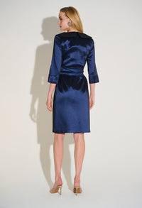 Woman wearing a blue dress against a white background