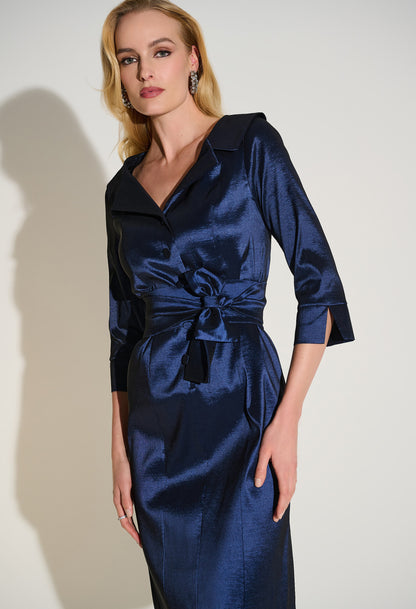 Woman wearing a blue satin dress against a white background