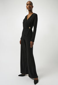 Woman wearing a black jumpsuit with a white background