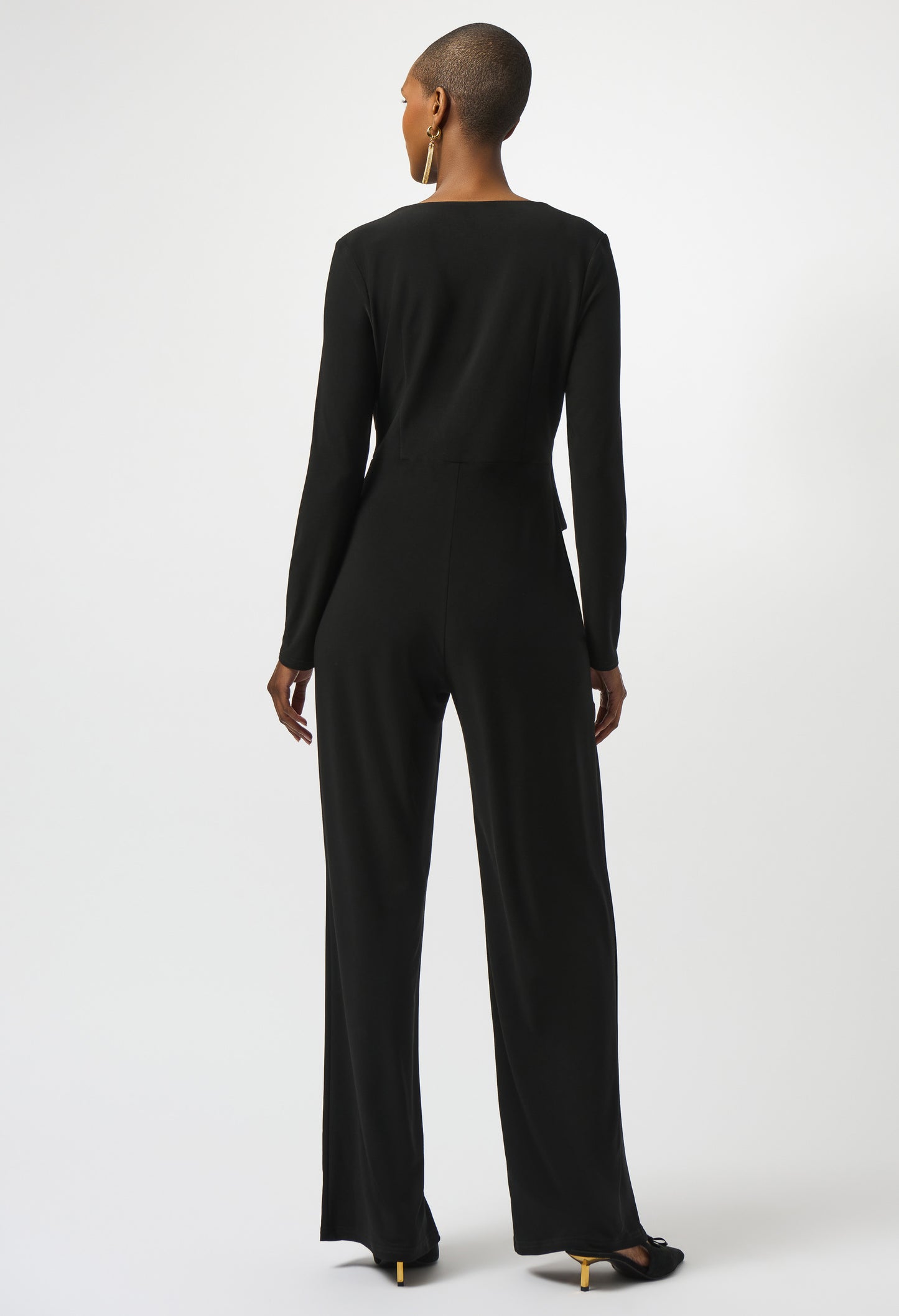 Person wearing a black jumpsuit on a white background