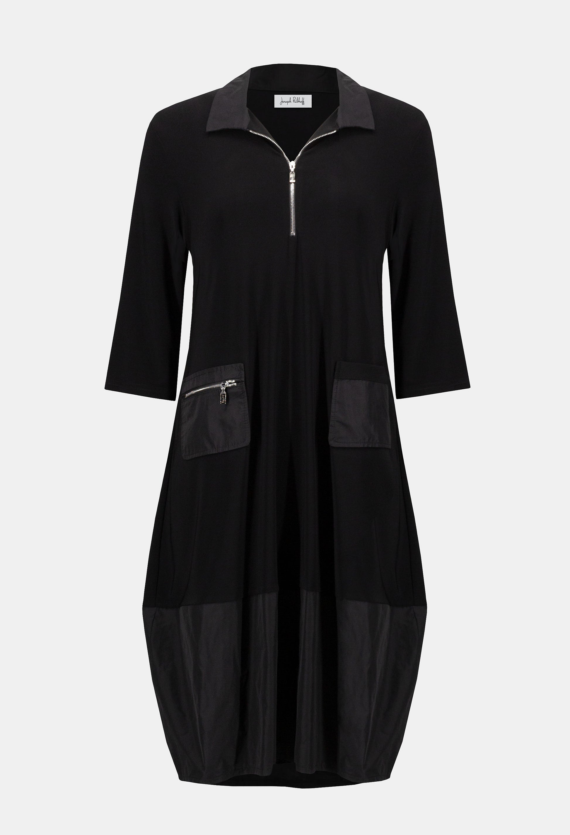 Black dress with zippers on a light gray background