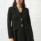 Woman wearing a black coat with gold buttons on a white background