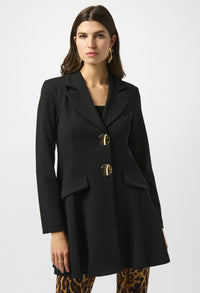 Woman wearing a black coat with gold buttons on a white background