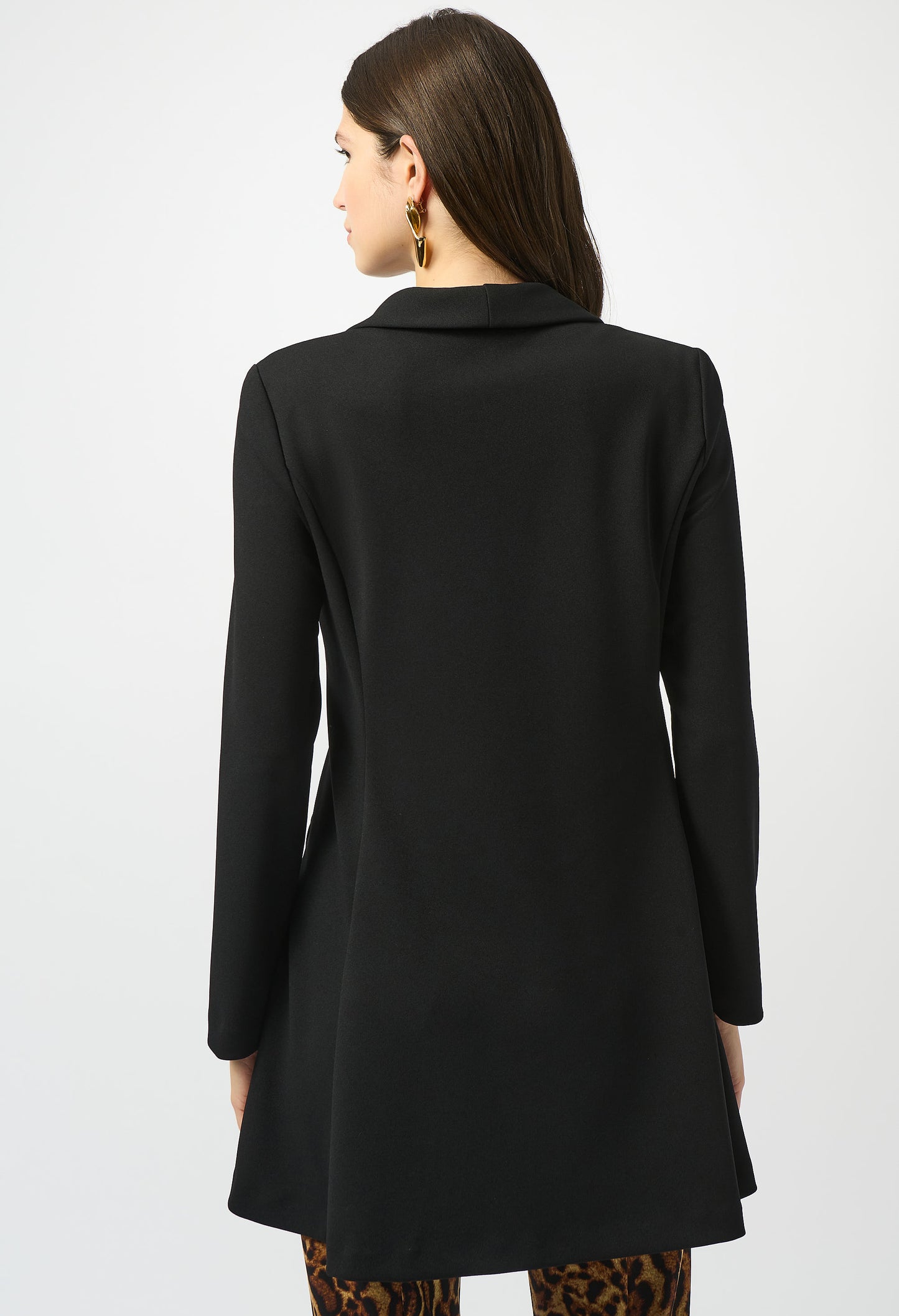 Woman wearing a black coat on a white background