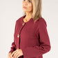 Woman wearing a burgundy blazer against a white background