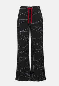 Black pants with white abstract pattern and red drawstring on a white background