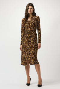 Woman wearing a leopard print dress on a white background