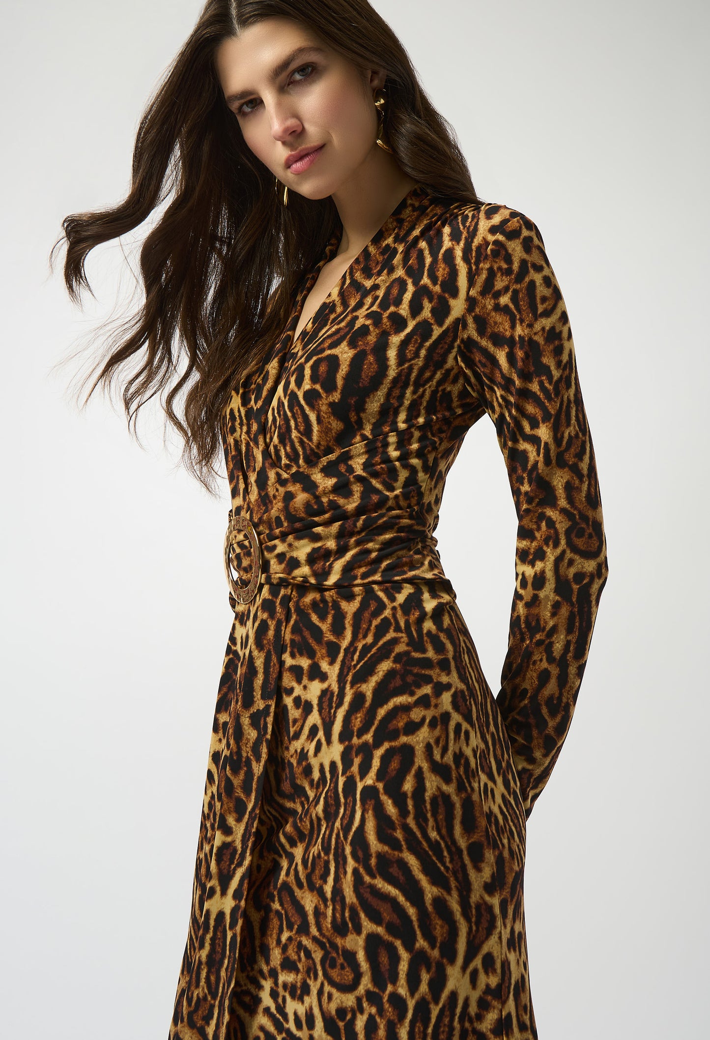 Woman wearing a leopard print dress on a white background