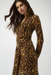 Woman wearing a leopard print dress on a white background