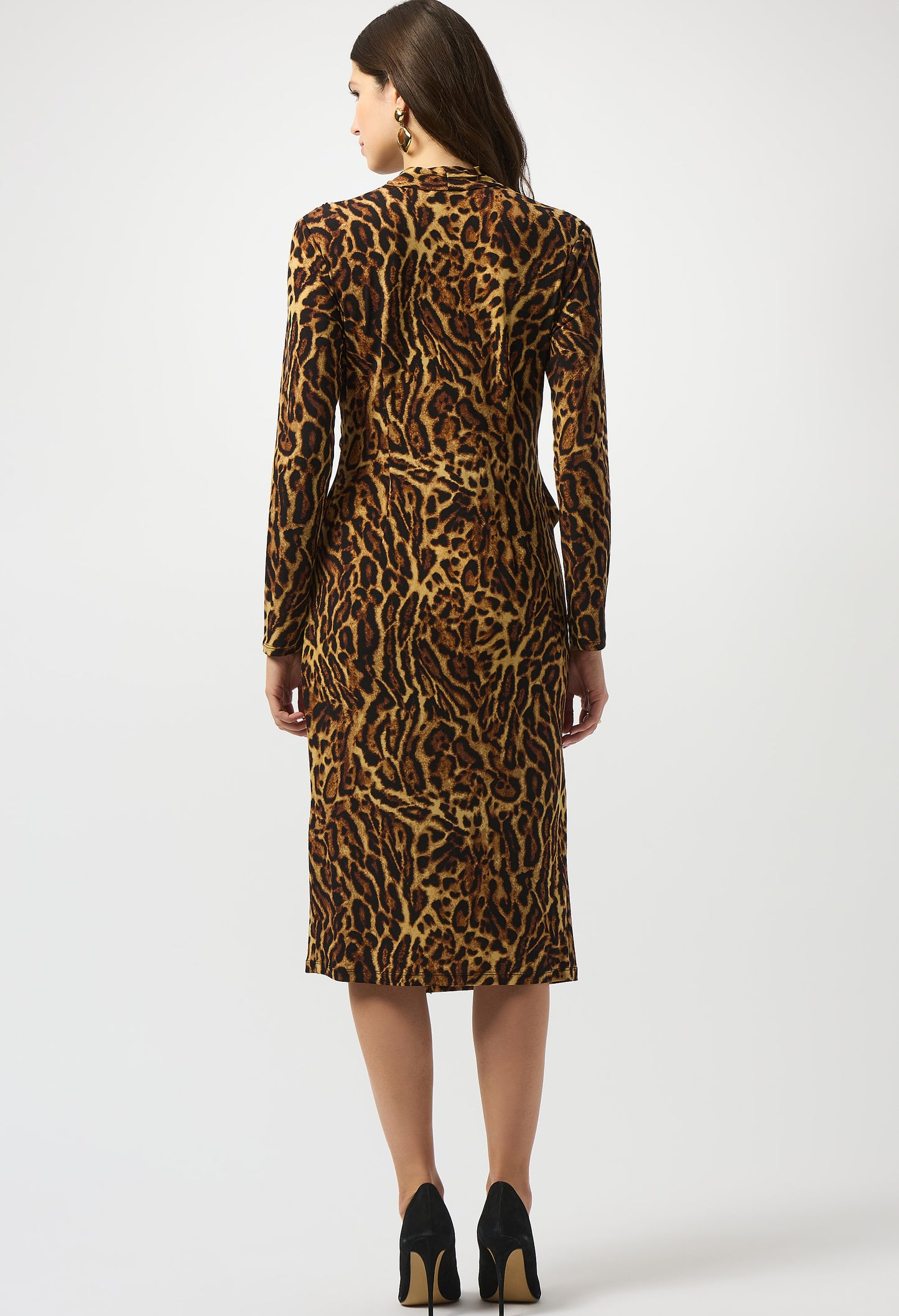 Woman wearing a leopard print dress on a white background