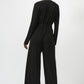 Black jumpsuit worn by a model on a white background