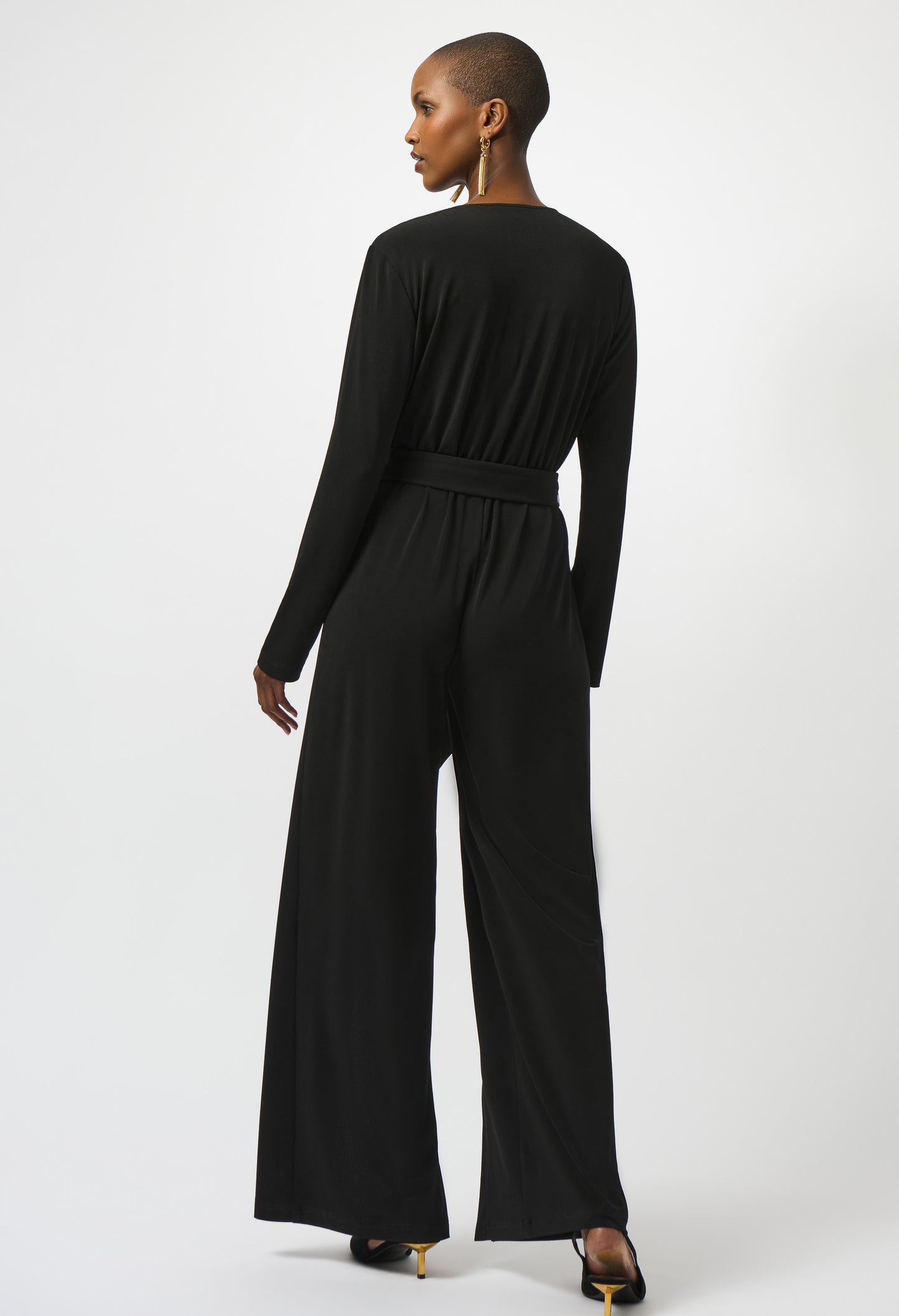 Black jumpsuit worn by a model on a white background