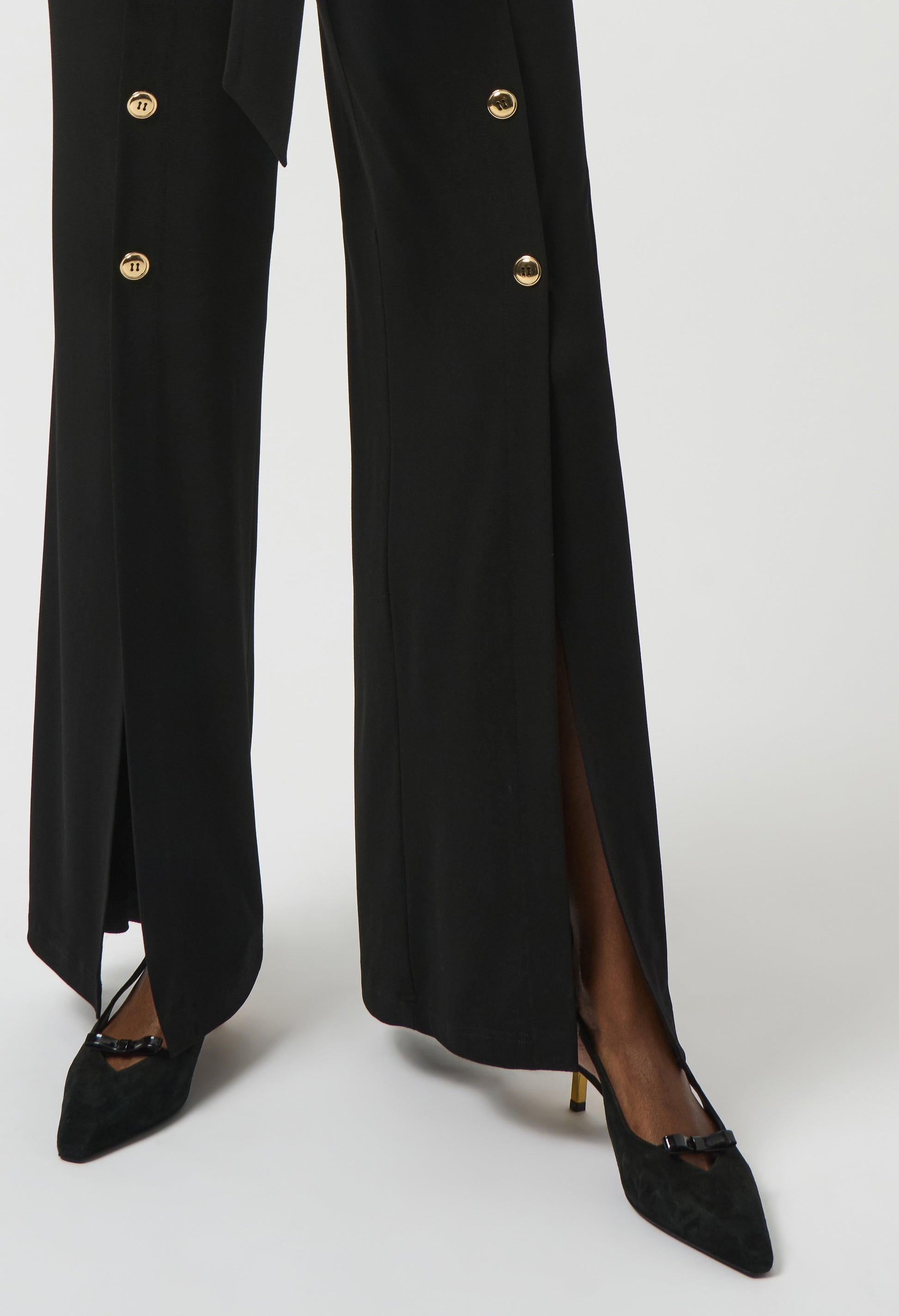 Black coat with gold buttons and black shoes on a white background