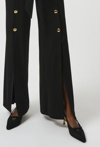 Black coat with gold buttons and black shoes on a white background